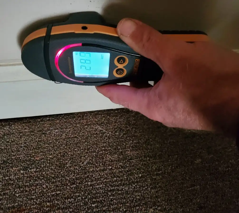 Moisture detection at baseboard during Storm Damage Restoration in Pooler